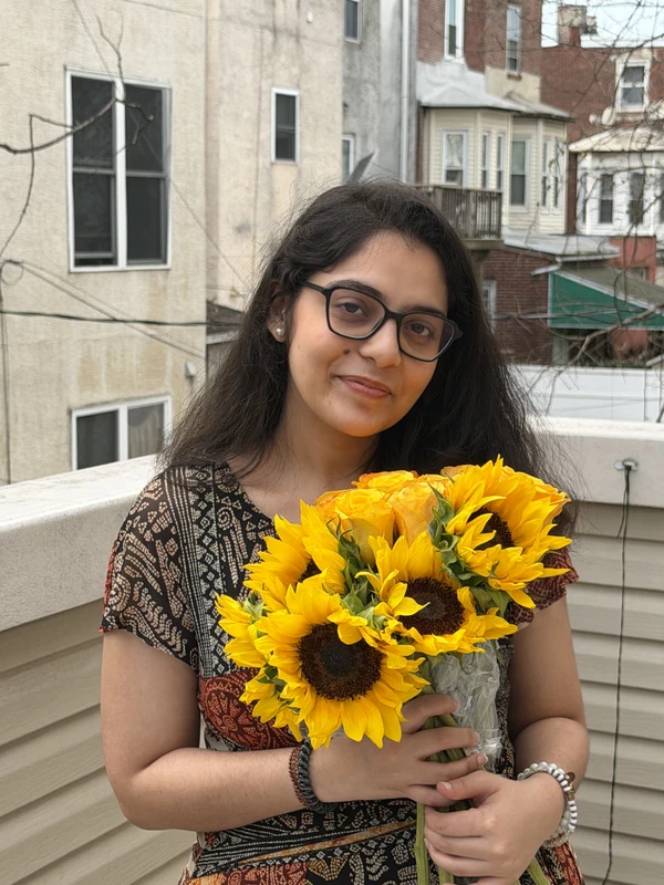 Suruchi holding a bouquet of sunflowers