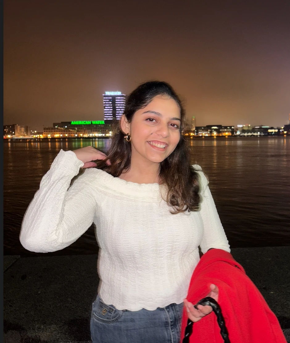 Suruchi Gokhale smiling by the waterfront at night